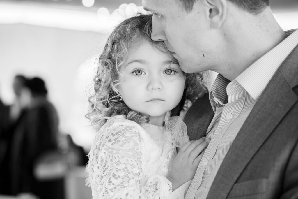 flower girl with dad by Lake of the Ozarks wedding photographer The Bennetts