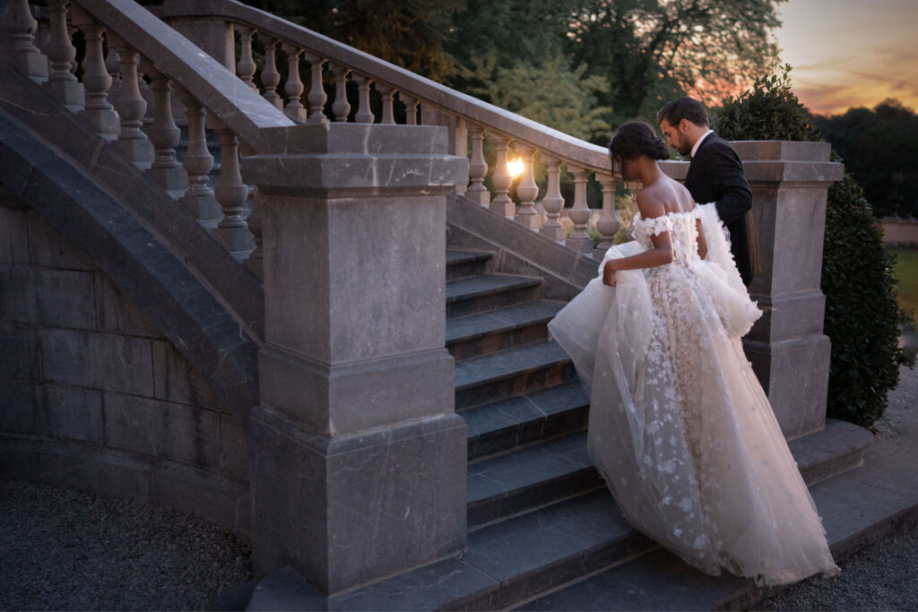 bride and groom walking down steps by Lake of the Ozarks wedding photographer The Bennetts