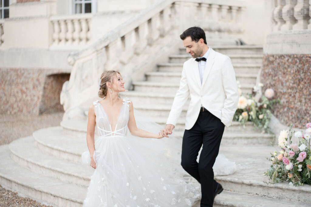 bride and groom walking down steps y Lake of the Ozarks wedding photographer The Bennetts