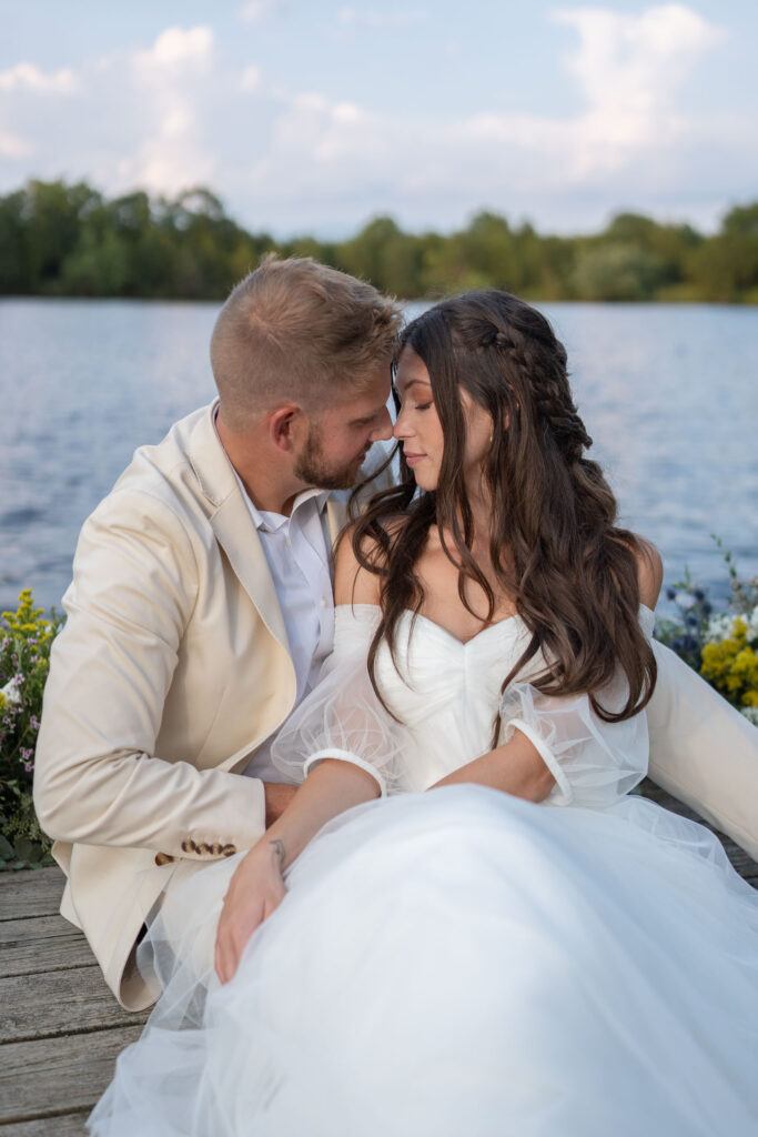 bride and groom by water by Lake of the Ozarks wedding photographer The Bennetts