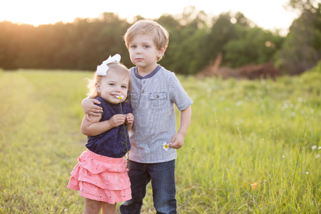 two kids in a field by Lake of the Ozarks photographer The Bennetts