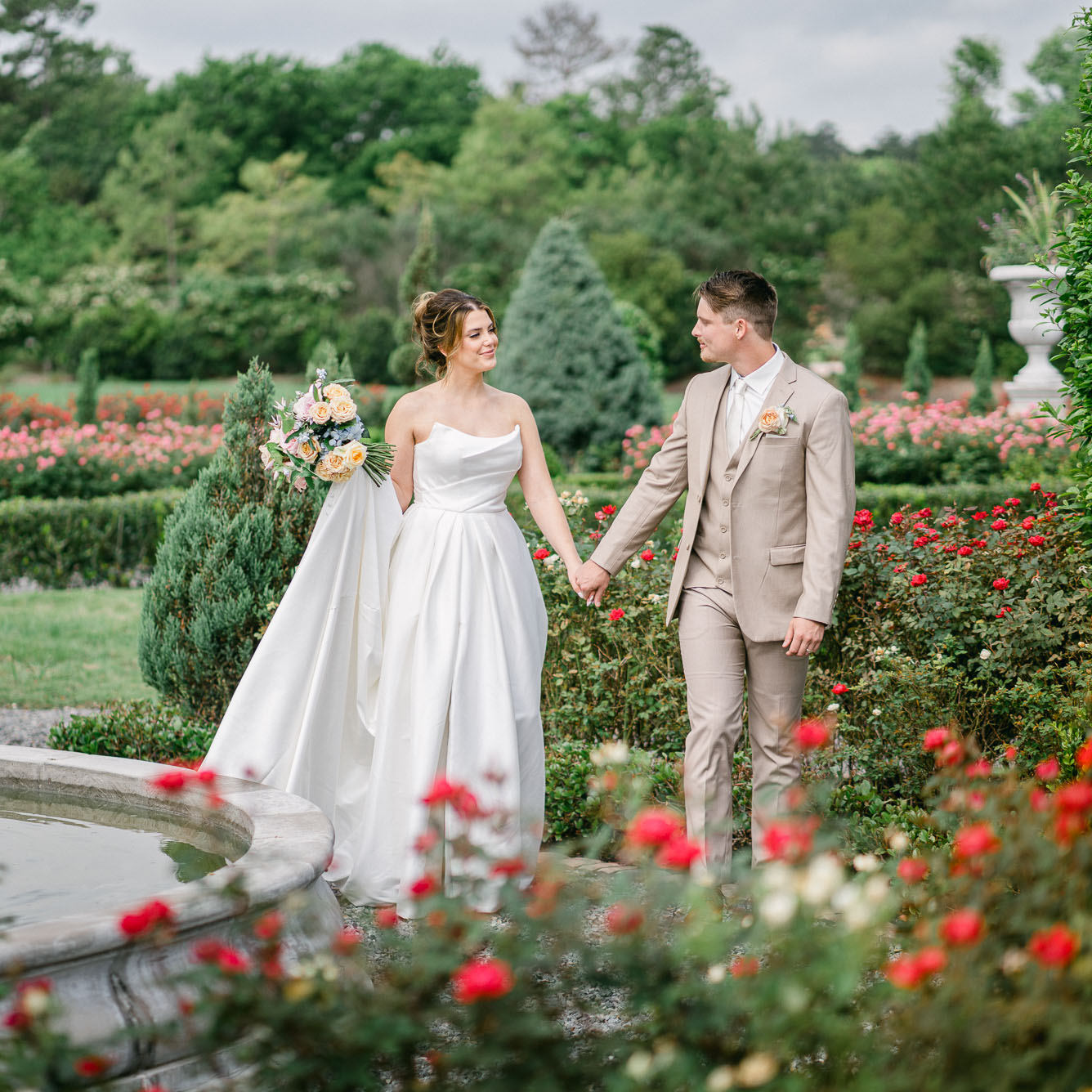 bride and groom in a rose garden by lake of the ozarks photographer The Bennetts