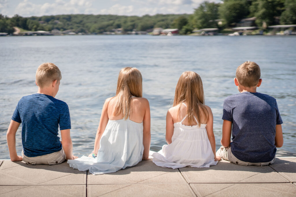 kids sitting on the dock by Lake of the Ozarks photographer The Bennetts