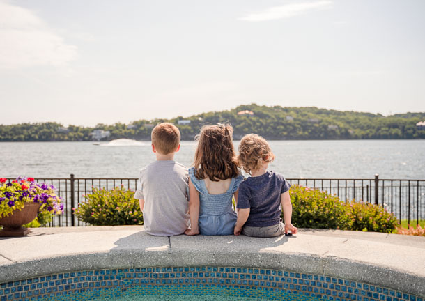 kids sitting by a pool by lake of the ozarks photographer